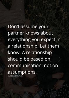 two people laying on the ground with their arms around each other and texting don't assume your partner knows about everything you expect in a relationship