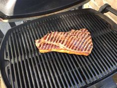 a piece of meat is cooking on a grill