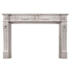 an antique white fireplace with carvings on the mantle and mantels, isolated against a white background