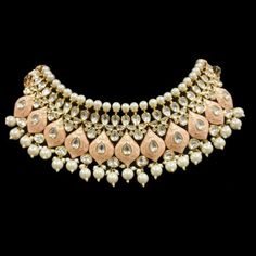 "A pure hand-drawn detailed jewelry in the shades of soft pink meena - this piece displays high-quality workmanship and fine usage of stones! Delicate necklace accented with kundan stones and faux pearls creating a lush, sparkling set. The set includes a pair of matching dangle earrings. Approximate earrings length is 3\". SET INCLUDES : Necklace & Earrings Tikka can be added to the set Details: Handcrafted Metal: Gold Plated, Metal Alloy Stone: Kundan & Meenakari Work Closure: Post for Elegant Pink Pearl Necklace For Festivals, Elegant Pink Chandbali Bridal Necklace, Pink Pearl Drop Chandbali Jewelry, Pink Pearl Drop Chandbali Earrings, Pink Meenakari Temple Jewelry Bridal Necklace, Pink Pearl Drop Jewelry For Festivals, Elegant Pink Bridal Necklace With Tilla, Elegant Pink Tilla Bridal Necklace, Handmade Pink Kundan Necklace