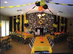 a party room with yellow and black decorations