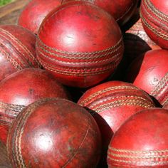 red leather cricket balls piled on top of each other