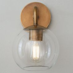 a light that is on the wall with a bulb in it's center and some lights around it