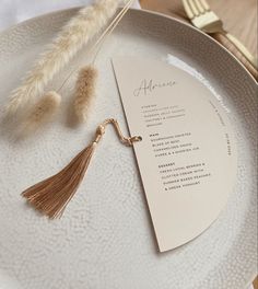 a white plate topped with a tasseled menu