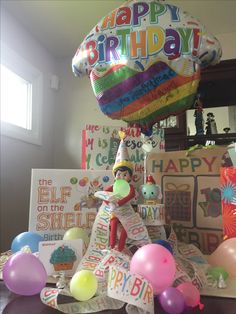 a birthday party with balloons, greeting cards and a cat in the hat balloon sculpture