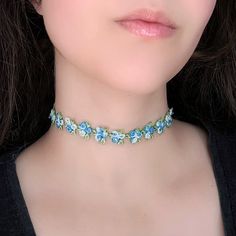 "A whimsical blue rose choker necklace that looks like it's straight out of a fairy garden! Featuring an intricate embroidered flower chain complete with tiny green leaves this gorgeous choker adds an elevated, floral accent to any look. The length shown in photos is 12\" and more options are available. Each size comes with an additional 2.5\" extender chain. When selecting necklace length, measure around the smallest part of your neck. If you're in between sizes, go for the next smallest size a Embroidery Choker, Rainbow Fringe, Purple Flower Necklace, Purple Choker, Rose Choker, Andara Crystal, Gold Pearl Jewelry, Rose Vine, Flower Chain