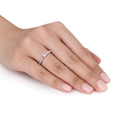 a woman's hand with a diamond ring on it