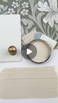 a white table topped with lots of papers and paint