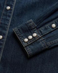 Our Denim Pearl Snaps are classically styled, making them perfect for both western traditionalists and trendsetters. Made with breathable 100% cotton denim in a special women’s cut with decisive antique brass-accented faux horn pearl snaps, and signature detailing on pockets and yoke, these shirts look great snapped or unsnapped and layered. Collared Denim Top With Snap Buttons, Embroidered Denim Button-up Shirt, Wrangler Pearl Snap Shirt, Vintage Pearl Snap Shirts, Pearl Snap Shirt, Denim Pocket, Belt Purse, Accessories Bags Purses, Pocket Shirt