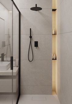 a bathroom with a walk in shower next to a white sink and counter top under a black faucet