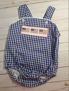 Boy smocked sunsuit * navy gingham sunsuit * 100% cotton * fully lined * snaps at the crotch * button at the shoulders * faux smocked flag design * ships within 5-7 business days Thanks for shopping with Sew Blessed Stitches!! We would love to connect with you on social media! You can find us at: Instagram@sewblessedstitches Facebook.com/sewblessedstitches Email - sewblessedstitches Boys Smock, Smocked Baby Clothes, Bubble Boy, Easter Applique, Personalized Easter Bunny, Navy Gingham, Personalized Backpack, Applique Shirts, Baby Diaper Bags