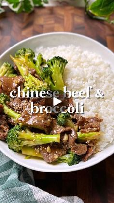 a white bowl filled with beef and broccoli next to rice on top of a wooden table