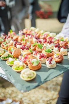 small appetizers are lined up on a table at an outdoor event, ready to be eaten