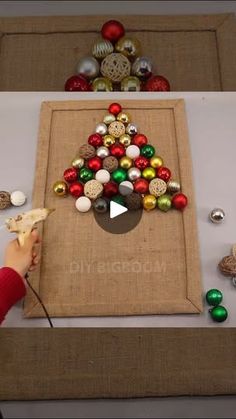 a person is making a christmas tree out of buttons and burlocked fabric