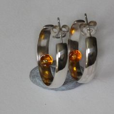 I make these solid sterling silver hoops with three options, Amber, a Pearl, or Turquoise, the small gem sits in the hoop making these very different, they are 25mm in diameter, 5mm wide, and 1.5mm thick, Sterling Silver Rounded Jewelry With Polished Finish, Silver Rounded Jewelry For Gift, Silver Oval Huggie Earrings For Gift, Silver Oval Huggie Earrings As A Gift, Oval Sterling Silver Huggie Earrings For Gift, Oval Sterling Silver Huggie Earrings As Gift, Modern Rounded Sterling Silver Jewelry, Hallmarked Oval Sterling Silver Hoop Earrings, Silver Rounded Earrings For Gifting