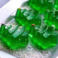 several pieces of green gummy bears on a white plate