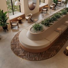 an aerial view of a lobby with chairs and plants