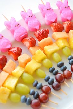 some fruit and marshmallows are arranged in the shape of rabbits on a stick