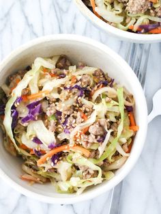 two white bowls filled with coleslaw and meat