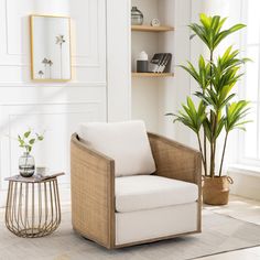 a white chair sitting next to a potted plant