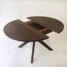 a wooden table with two open drawers on it's top and one drawer at the bottom