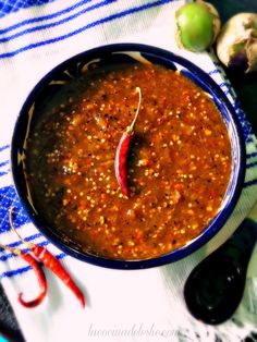 a blue bowl filled with red chili sauce