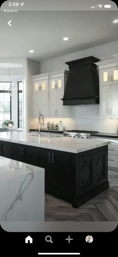 an iphone photo of a kitchen with white cabinets and black appliances on the left side