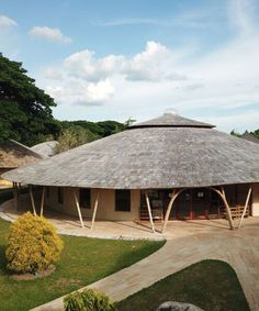 an outside view of a building with a thatched roof