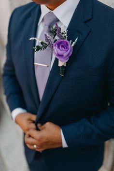 a man in a suit and tie with a boutonniere on his lapel