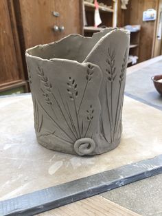 a clay vase sitting on top of a table