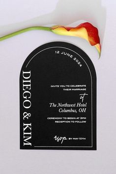 a black and white wedding card with a flower