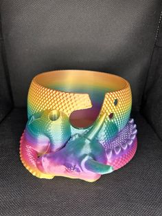 a colorful bracelet sitting on top of a gray chair