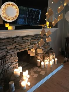 candles are lit in front of a fireplace with notes taped to it and hanging from the mantle