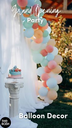 a cake sitting on top of a white pedestal under balloons that say you've balloones look so amazing