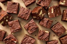 chocolate brownies cut into squares next to a bowl of frosting on a table