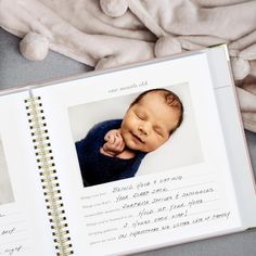 a baby's first year book is opened to show the birth pictures and handwritten words