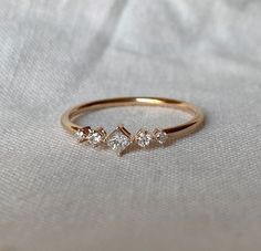 a gold ring with three diamonds on it