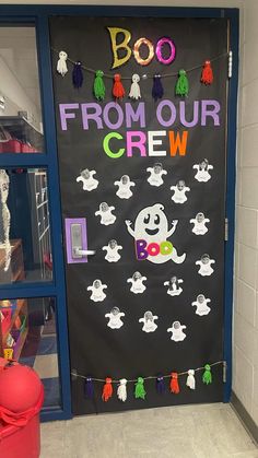 a door decorated with halloween decorations and the words boo from our crew