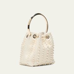 Jimmy Choo "Bon Bon" bucket bag in allover pearly satin viscose, brass, and ABS Flat metal top handle  Drawstring closure  Approx. 5.9"h x 5.5"W x 3.7"D Item Weight (Lbs.): 1.0 Made in Italy Luxury Handheld Bucket Bag For Evening, Evening Handheld Bucket Bag With Gold-tone Hardware, Luxury Handheld Bucket Bag For Formal Occasions, Luxury Formal Handheld Bucket Bag, White Party Bags With Gold-tone Hardware, Gold Handheld Bucket Bag With Gold-tone Hardware, Gold Bucket Shoulder Bag For Formal Occasions, Elegant Evening Bucket Bag With Top Handle, Party Bucket Bag With Top Handle