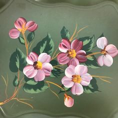 a painting of pink flowers with green leaves on a gray background, painted in acrylic paint