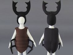 two mannequins dressed in costumes made to look like bugs and antlers