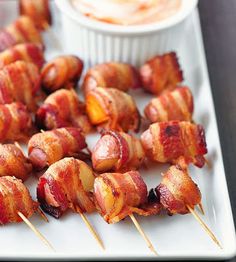 bacon wrapped chicken on skewers with dip in the background and text that reads yummy finger food recipe