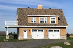 a two story house with three garages on each side