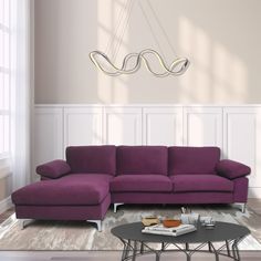 a living room with a purple couch and coffee table