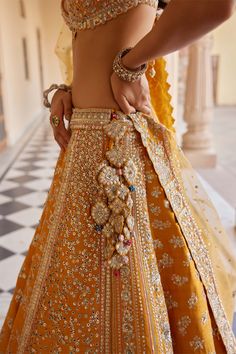 Step into vibrant elegance with our orange peel embroidered lehenga, meticulously handcrafted with zardozi, french knots, aari work, and delicate dori embroidery. This exquisite ensemble combines traditional craftsmanship with modern sophistication, perfect for weddings and special occasions. The striking orange peel hue exudes warmth and charm, while the intricate embroidery adds a touch of regal allure. Ideal for those who appreciate meticulous detailing and timeless style, this lehenga set pr Orange Wedding Lehenga, Grey Lengha, American Indian Dress, Shadi Ideas, India Outfits, Dori Embroidery, Desi Fits, Makeup Images, Embroidered Lehenga