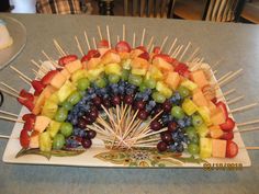 a rainbow shaped fruit skewer on a table