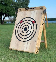 a wooden target board sitting in the grass