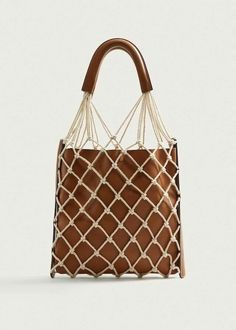 a brown and white handbag with rope handles