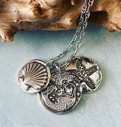 "This silver Mermaid pendant is made from .999 fine silver. Fine silver has a higher silver content than sterling silver. This is a very detailed impression from a wax seal designed by J Wu Moments.  7/8\" diameter." Silver Sterling Silver Mermaid Necklaces, Ocean-inspired Silver Charm Necklace With Lobster Clasp, Ocean-inspired Silver Necklaces With Charms, Ocean-inspired Silver Charms Jewelry, Ocean-inspired Silver Round Pendant Jewelry, Ocean-inspired Silver Sterling Charm Necklaces, Ocean-inspired Sterling Silver Charm Necklaces, Silver Pendant Charm Necklace Stamped, Silver Stamped Pendant Charm Necklace