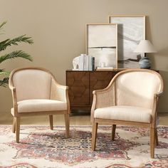 two chairs sitting next to each other on top of a rug